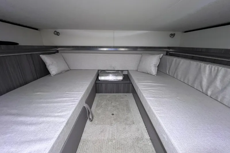 Slide: The Image of Interior cabin of 2022 Sea Ray Sundancer 320 Coupe Outboard, featuring sleek gray seating. - 46
