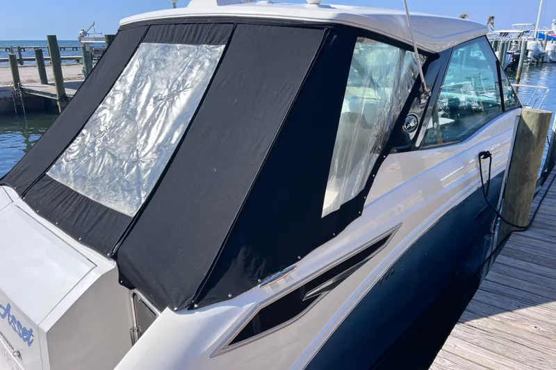 Slide: The Image of 2022 Sea Ray Sundancer 320 Coupe Outboard docked at a marina. - 48
