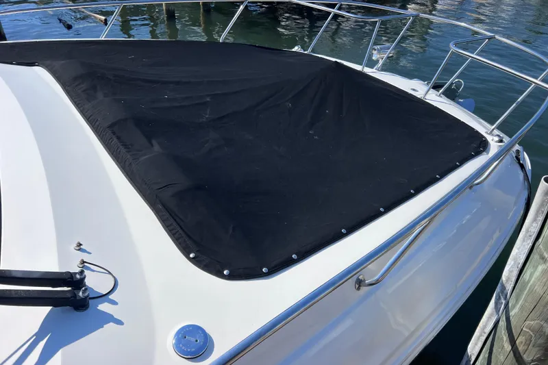 Slide: The Image of 2022 Sea Ray Sundancer 320 Coupe Outboard with black cover on deck. - 49