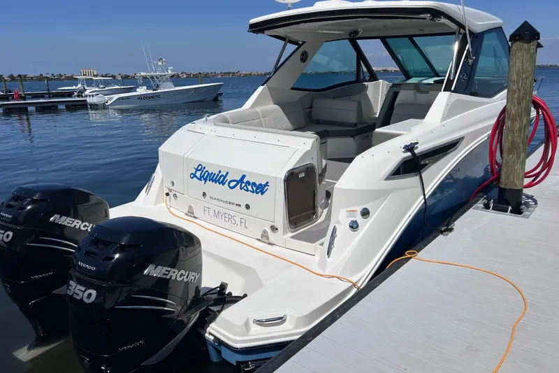 Slide: The Image of 2022 Sea Ray Sundancer 320 Coupe Outboard docked, featuring twin Mercury engines. - 9