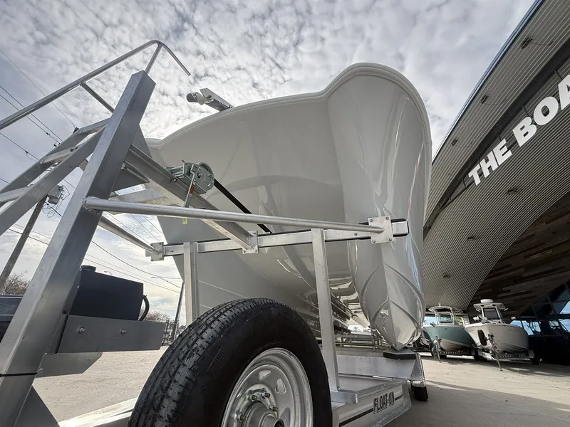 Slide: The Image of 2026 Twin Vee 280 GFX2 boat on trailer under cloudy sky. - 12