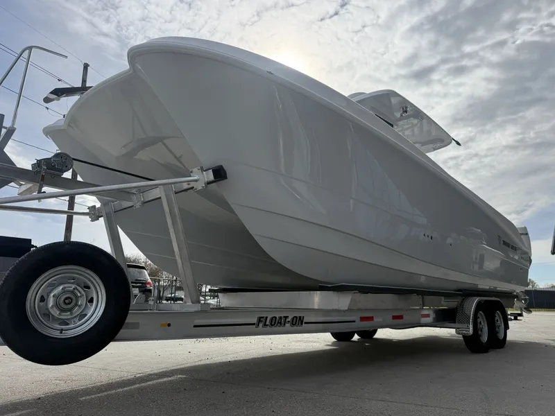Slide: The Image of 2026 Twin Vee 280 GFX2 boat on trailer under cloudy sky. - 13