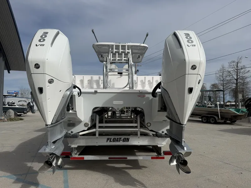 Slide: The Image of Rear view of 2026 Twin Vee 280 GFX2 boat with dual outboard engines. - 2
