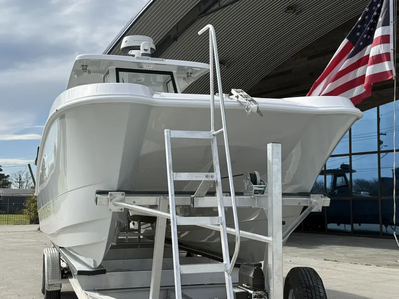 Slide: The Image of 2026 Twin Vee 280 GFX2 boat on trailer with American flag. - 5