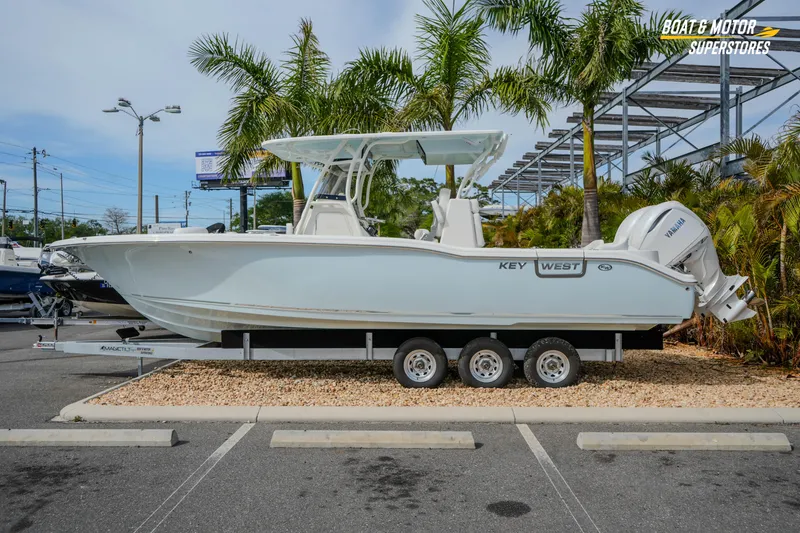 The Image of 2026 Key West 291 FS boat on trailer, displayed outdoors with palm trees. - 1