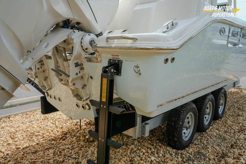 Slide: The Image of 2026 Key West 291 FS boat on trailer, rear view with dual engines. - 10