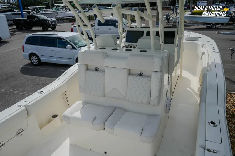 Slide: The Image of 2026 Key West 291 FS boat interior with seating and console, parked in a marina. - 13