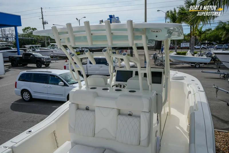 Slide: The Image of 2026 Key West 291 FS boat displayed at dealership with vehicles in background. - 14