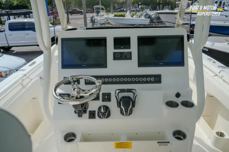 Slide: The Image of 2026 Key West 291 FS boat dashboard with dual screens and steering wheel. - 20