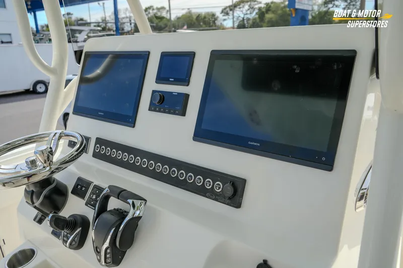 Slide: The Image of 2026 Key West 291 FS boat dashboard with dual Garmin displays and controls. - 23