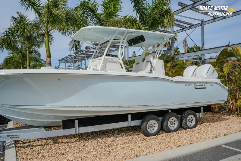 Slide: The Image of 2026 Key West 291 FS boat on trailer, surrounded by palm trees. - 3