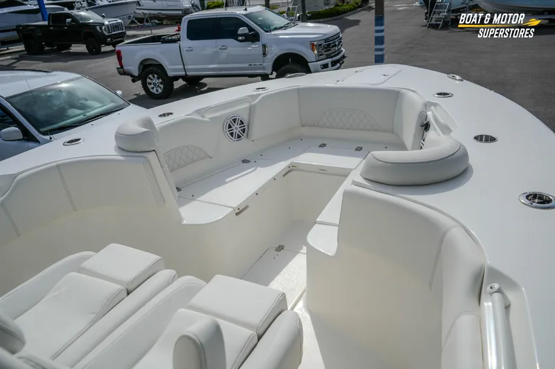 Slide: The Image of 2026 Key West 291 FS boat interior with white seating and cup holders. - 30