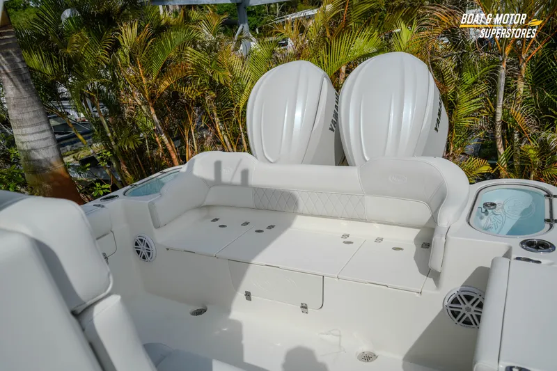 Slide: The Image of 2026 Key West 291 FS boat interior with seating and twin engines, surrounded by lush greenery. - 42