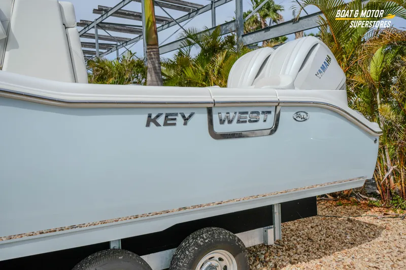 Slide: The Image of 2026 Key West 291 FS boat side view with Yamaha engines, parked on a trailer. - 5