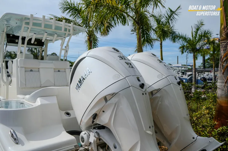Slide: The Image of 2026 Key West 291 FS boat with Yamaha engines, displayed outdoors near palm trees. - 7