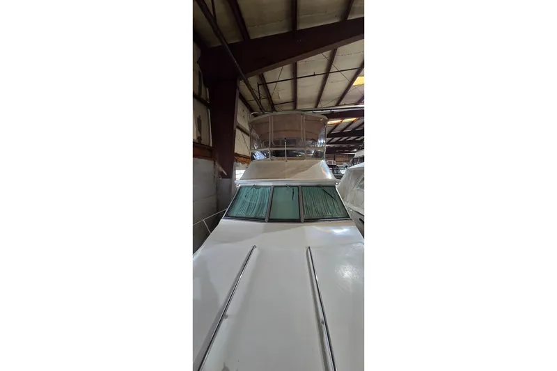 The Image of 1987 Sea Ray 340 Sedan Bridge yacht in indoor storage facility. - 0