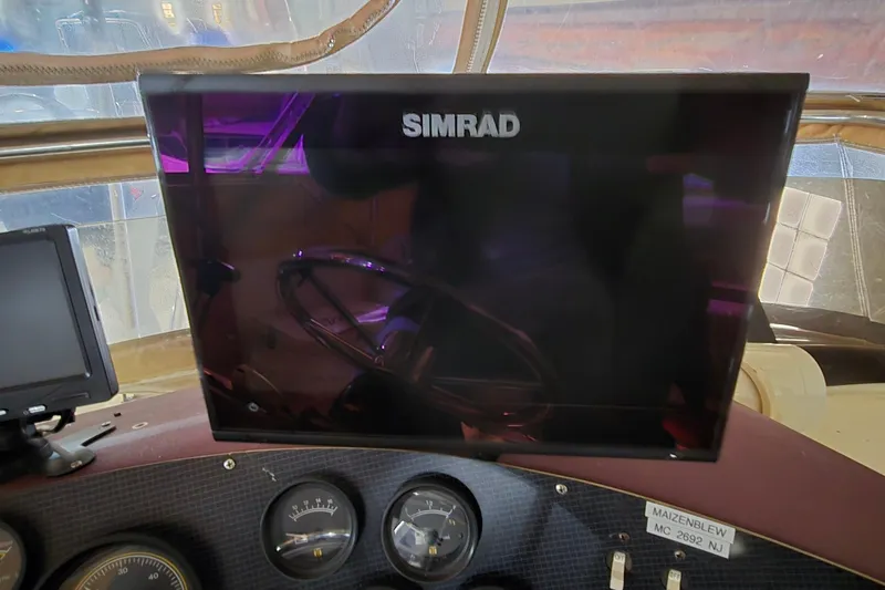 Slide: The Image of Dashboard of a 1987 Sea Ray 340 Sedan Bridge with Simrad display and gauges. - 12