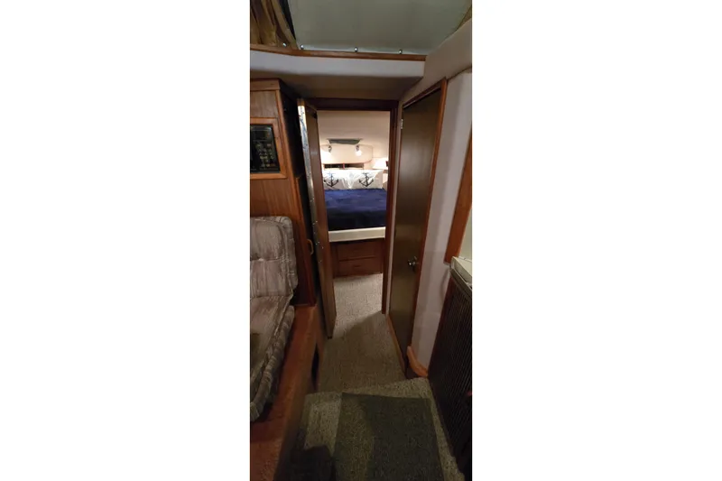 Slide: The Image of Interior view of 1987 Sea Ray 340 Sedan Bridge, featuring cozy cabin hallway. - 19