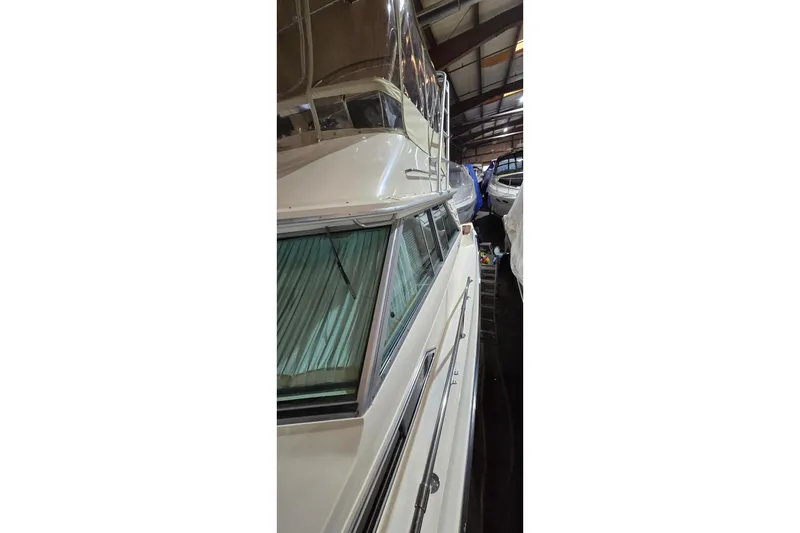 Slide: The Image of 1987 Sea Ray 340 Sedan Bridge yacht in indoor storage facility. - 2