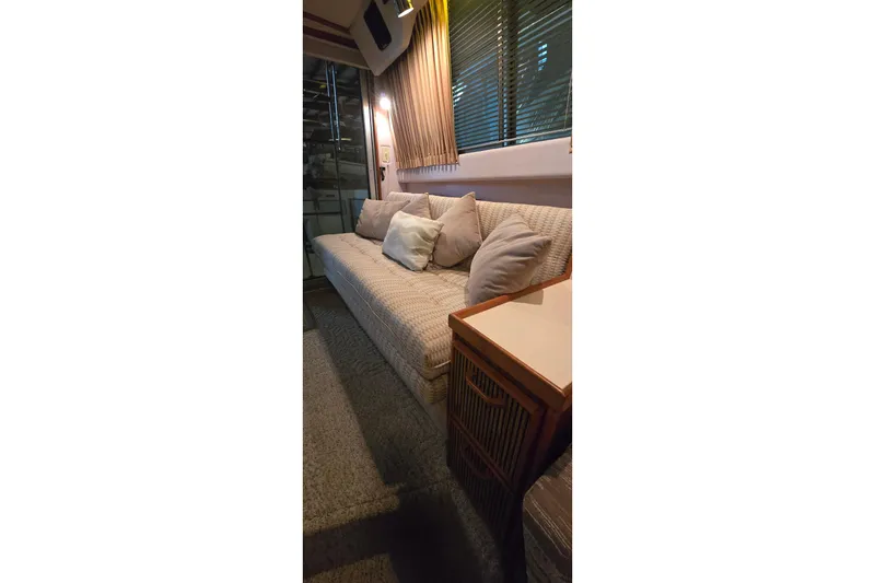 Slide: The Image of Interior of 1987 Sea Ray 340 Sedan Bridge with cozy seating and cushions. - 28