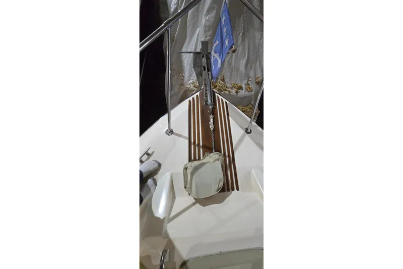 Slide: The Image of 1987 Sea Ray 340 Sedan Bridge bow with flag and wooden deck accents. - 3