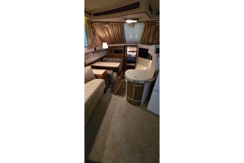 Slide: The Image of Interior of 1987 Sea Ray 340 Sedan Bridge with cozy seating and elegant decor. - 31