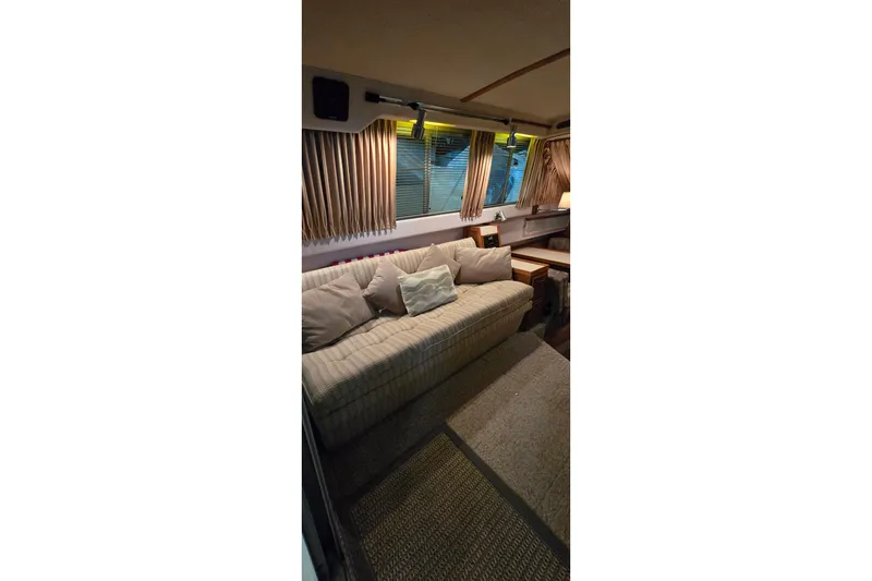Slide: The Image of Interior of 1987 Sea Ray 340 Sedan Bridge with cozy seating and ambient lighting. - 32