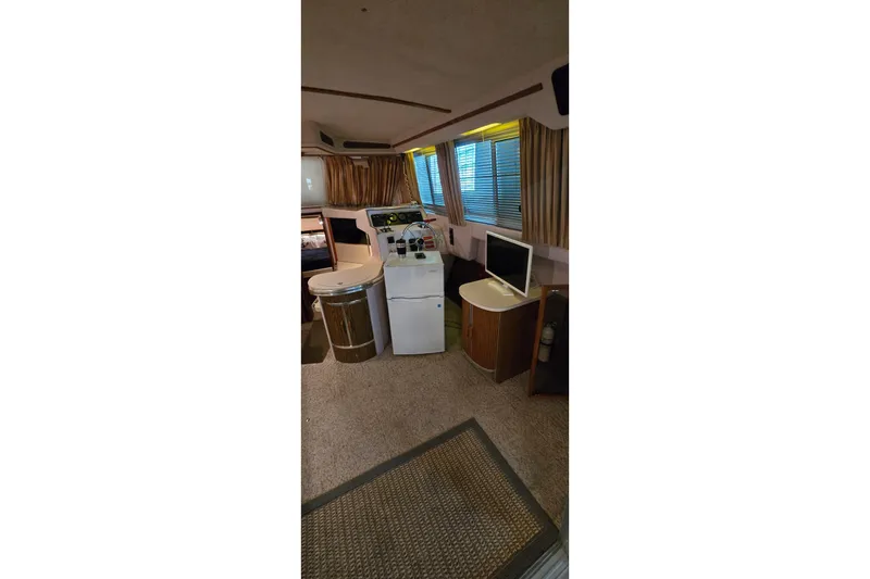 Slide: The Image of Interior of 1987 Sea Ray 340 Sedan Bridge with helm, seating, and windows. - 33
