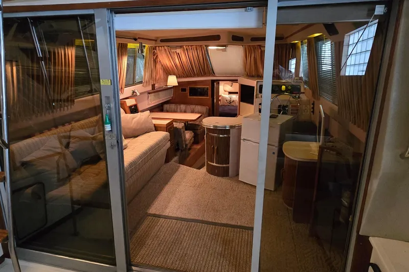 Slide: The Image of Interior of 1987 Sea Ray 340 Sedan Bridge yacht, featuring cozy seating and elegant decor. - 34