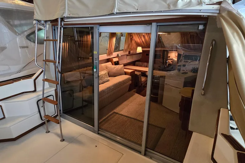 Slide: The Image of 1987 Sea Ray 340 Sedan Bridge interior with cozy seating and elegant decor. - 35