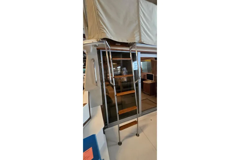 Slide: The Image of 1987 Sea Ray 340 Sedan Bridge interior with ladder and cabin view. - 36