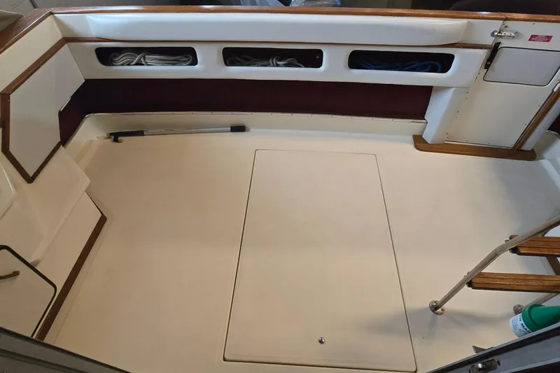 Slide: The Image of 1987 Sea Ray 340 Sedan Bridge boat interior with storage compartments and wooden accents. - 40