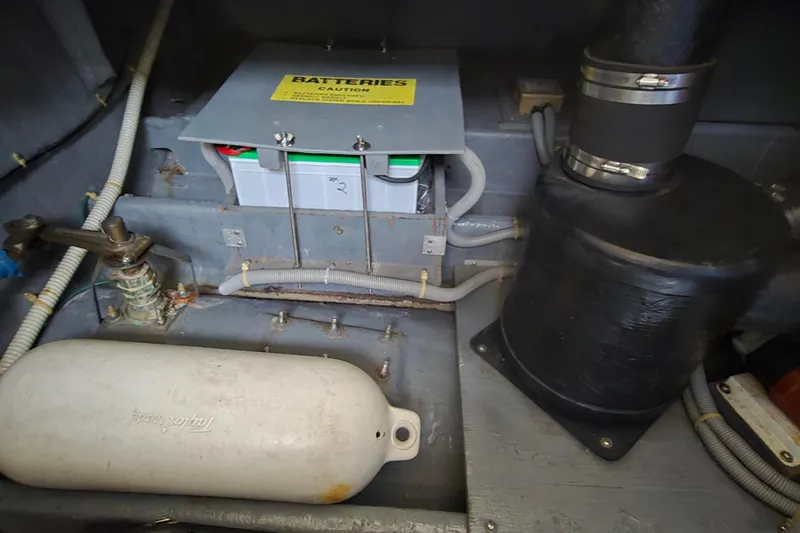 Slide: The Image of Engine compartment of 1987 Sea Ray 340 Sedan Bridge showing battery and components. - 44