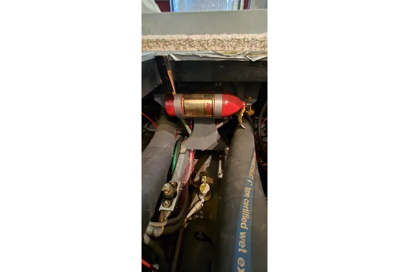 Slide: The Image of Engine compartment of a 1987 Sea Ray 340 Sedan Bridge with fire extinguisher system. - 51