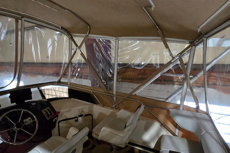 Slide: The Image of Interior view of 1987 Sea Ray 340 Sedan Bridge with helm and seating area. - 6