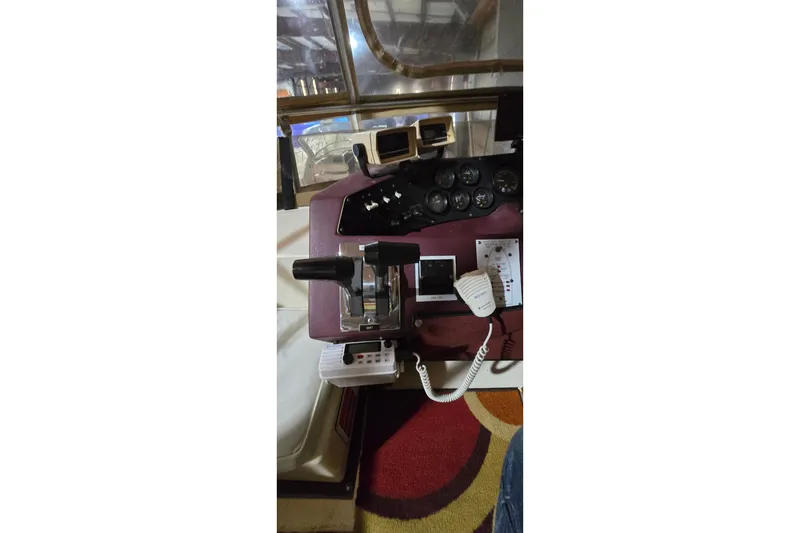 Slide: The Image of 1987 Sea Ray 340 Sedan Bridge helm with controls and gauges. - 9
