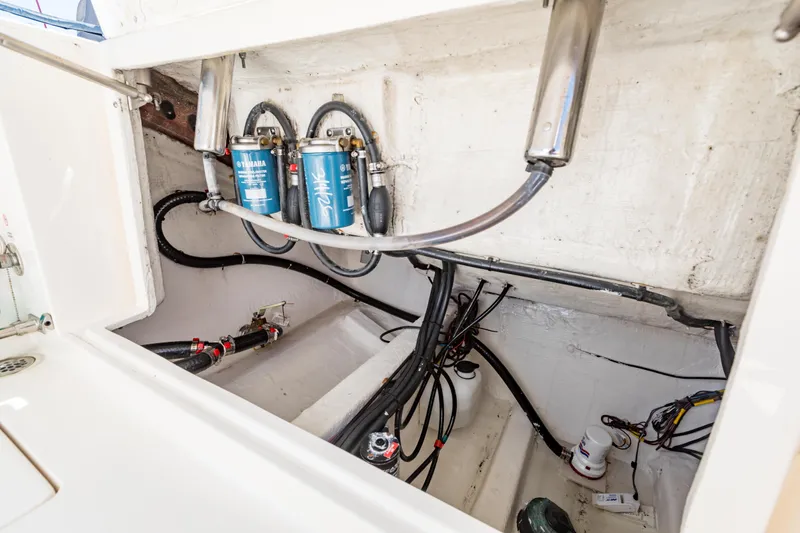Slide: The Image of Engine compartment of 2023 Cobia 240 Center Console with Yamaha filters and wiring. - 13