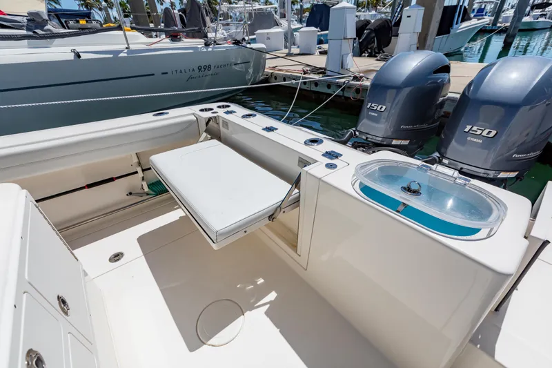 Slide: The Image of 2023 Cobia 240 Center Console boat with Yamaha engines docked at marina. - 14
