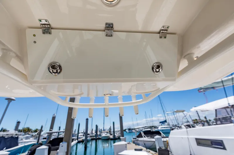 Slide: The Image of 2023 Cobia 240 Center Console boat detail with marina background. - 20