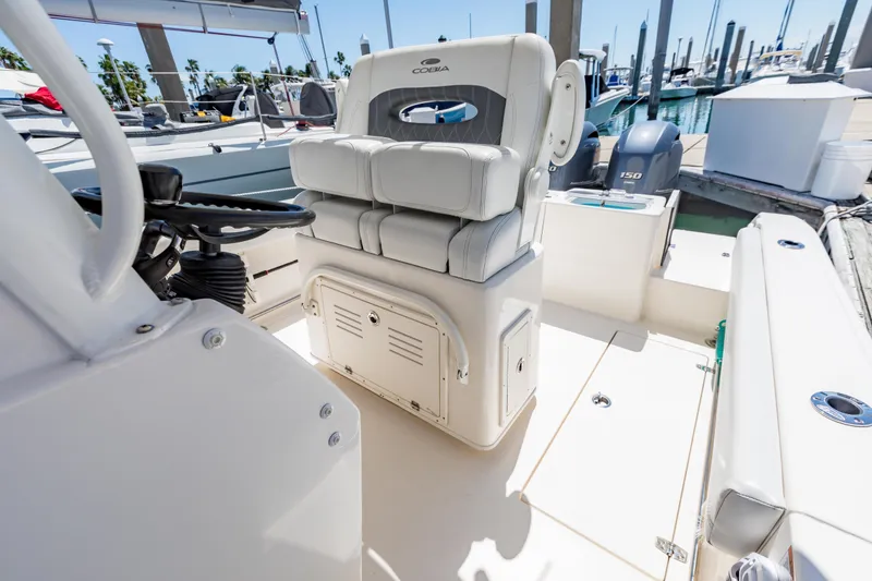 Slide: The Image of 2023 Cobia 240 Center Console boat interior with helm seat and outboard motor. - 24