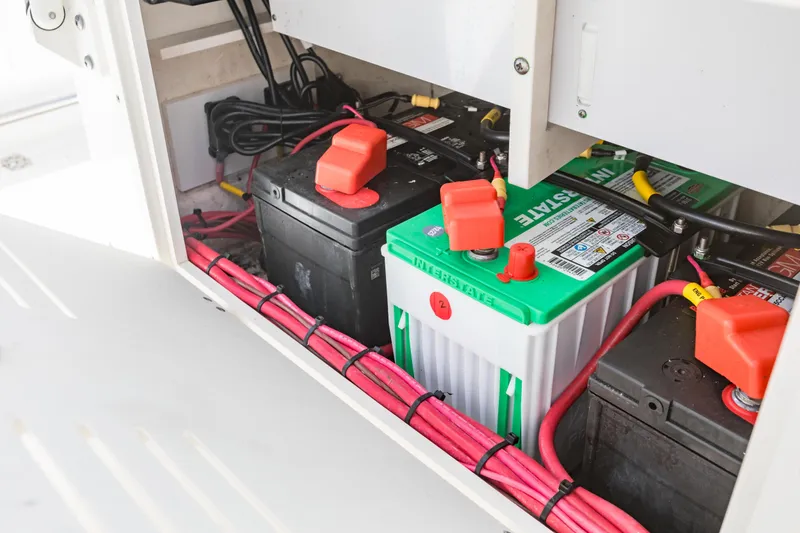 Slide: The Image of Battery compartment of 2023 Cobia 240 Center Console with neatly arranged cables. - 36