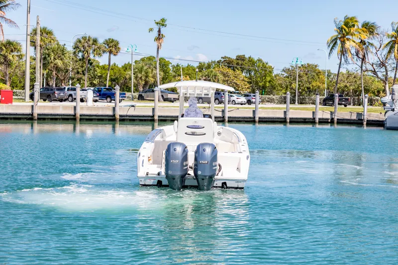 Slide: The Image of 2023 Cobia 240 Center Console boat with dual engines on calm water. - 7