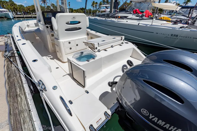 Slide: The Image of 2023 Cobia 240 Center Console boat docked with Yamaha engines. - 9
