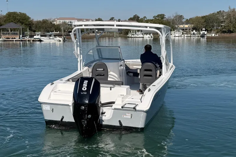 Slide: The Image of 2024 Sea Pro 240 Dual Console boat cruising on a calm lake. - 13