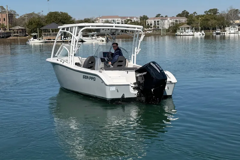 Slide: The Image of 2024 Sea Pro 240 Dual Console boat on calm water with Mercury engine. - 15