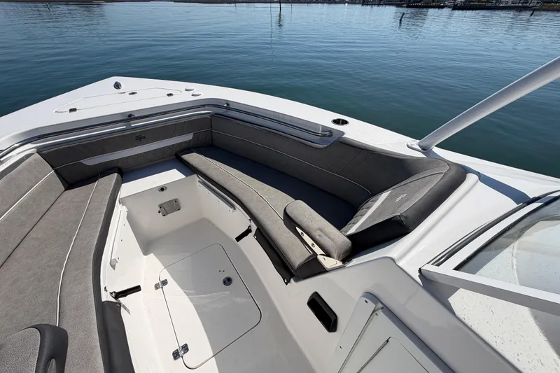 Slide: The Image of 2024 Sea Pro 240 Dual Console boat interior with gray seating and open water view. - 23