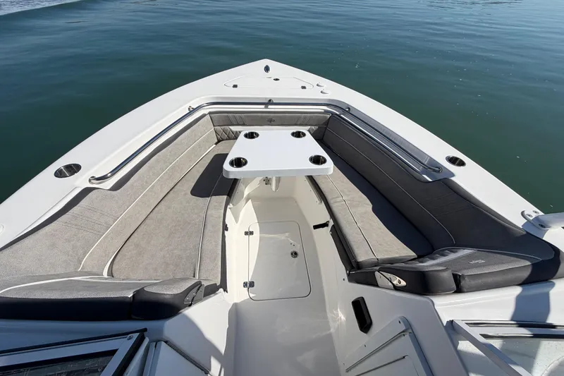 Slide: The Image of 2024 Sea Pro 240 Dual Console boat with spacious seating and table on calm water. - 26