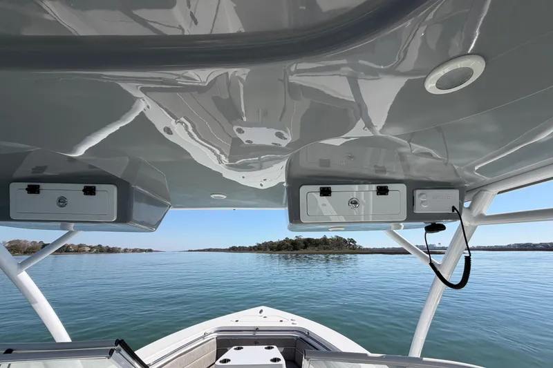 Slide: The Image of 2024 Sea Pro 240 Dual Console boat interior with ocean view and storage compartments. - 29