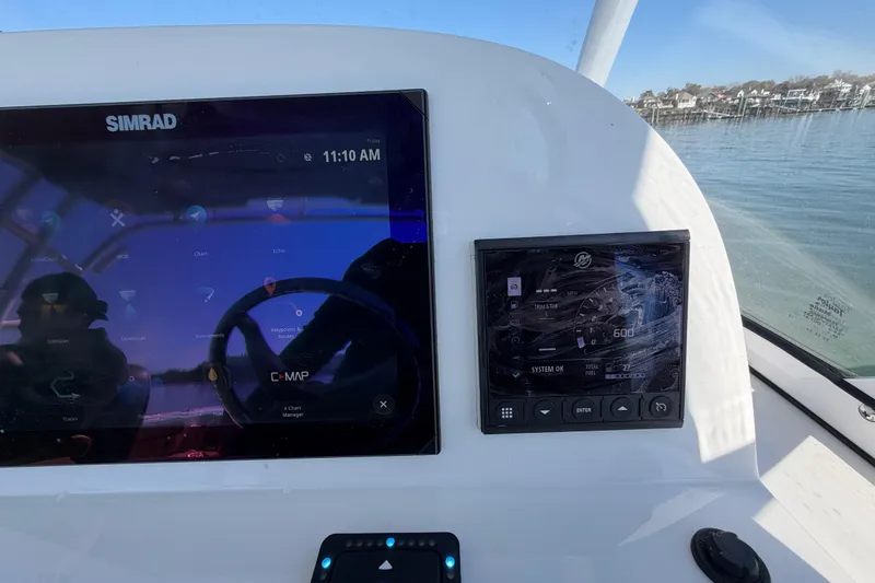 Slide: The Image of 2024 Sea Pro 240 Dual Console dashboard with Simrad navigation display and control panel. - 35