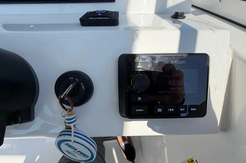 Slide: The Image of Control panel of 2024 Sea Pro 240 Dual Console boat with audio system and ignition. - 37